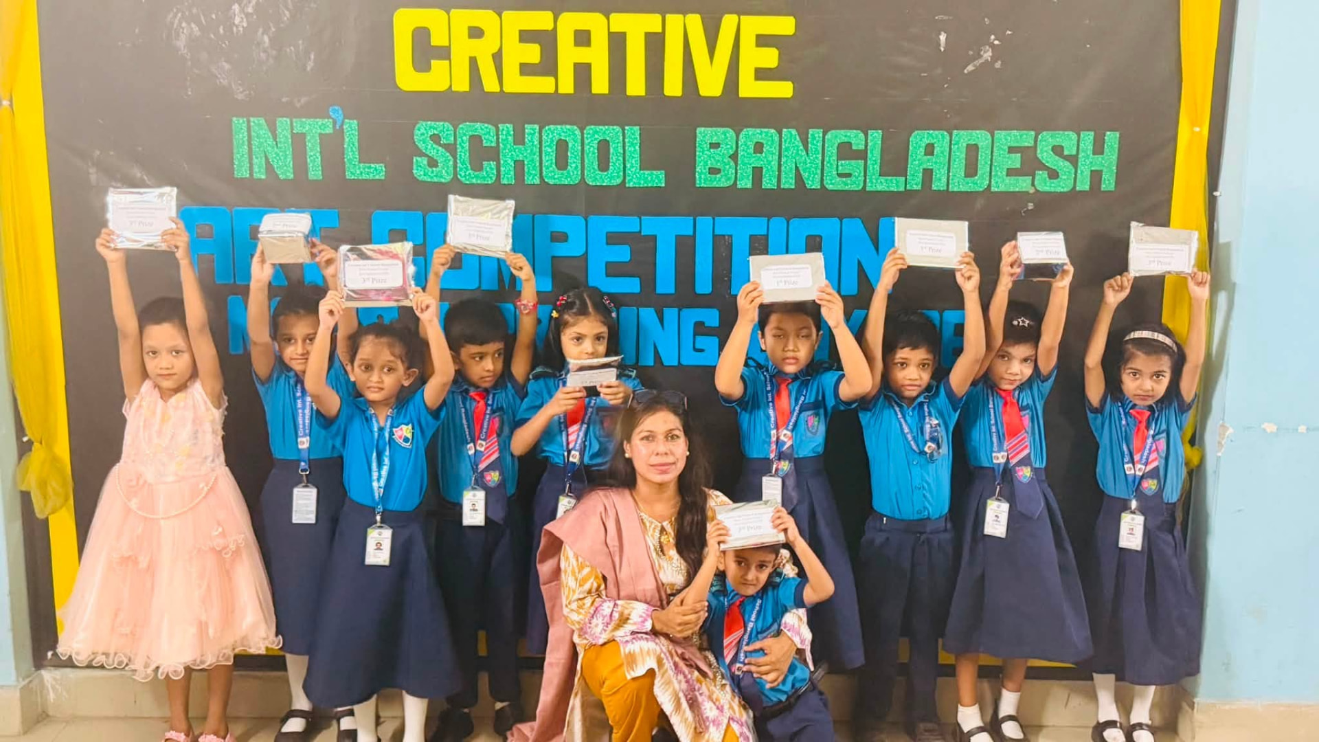 Students holding their prizes at the Creative International School Bangladesh art competition